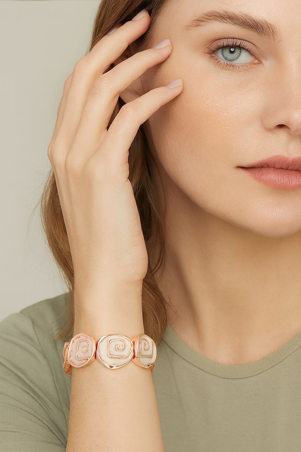 Woman wearing hand-painted enamel heart bracelet in pastel pink and blue