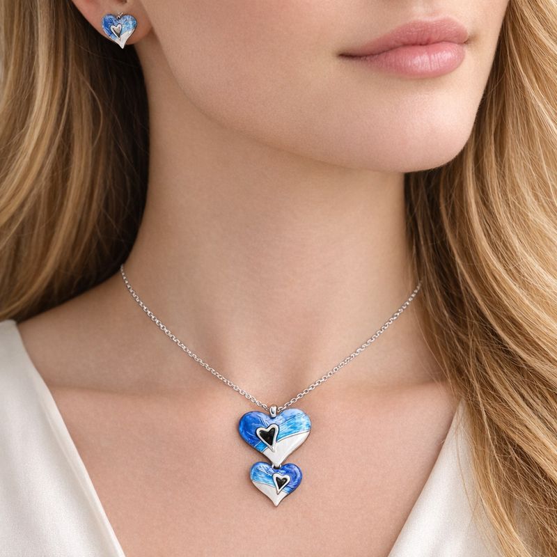 lose up of hand painted enamel heart jewelry with KC gold plating texture