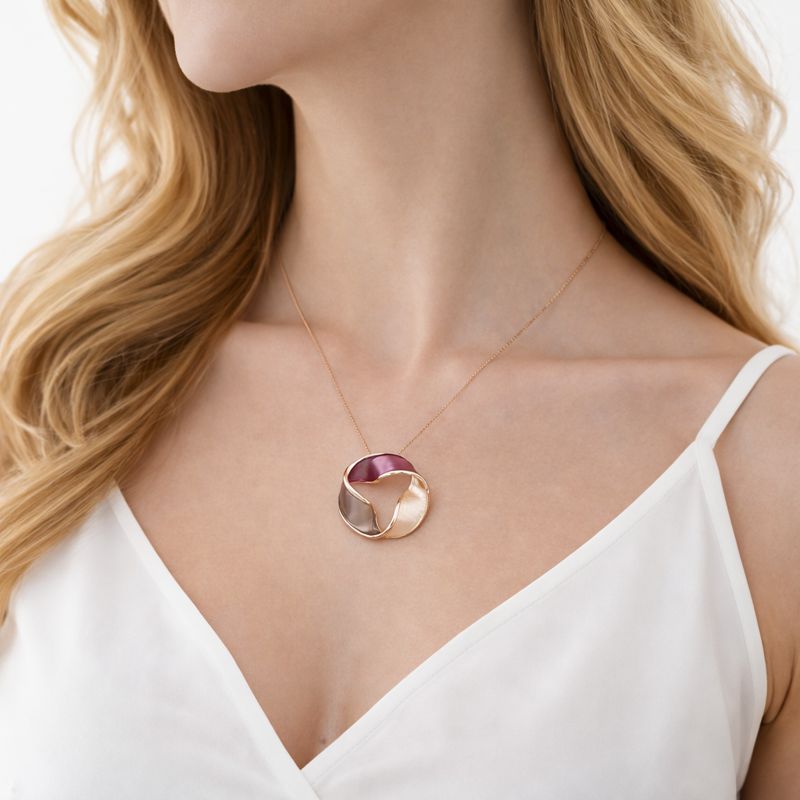 Close up of hand painted enamel KC gold plated necklace