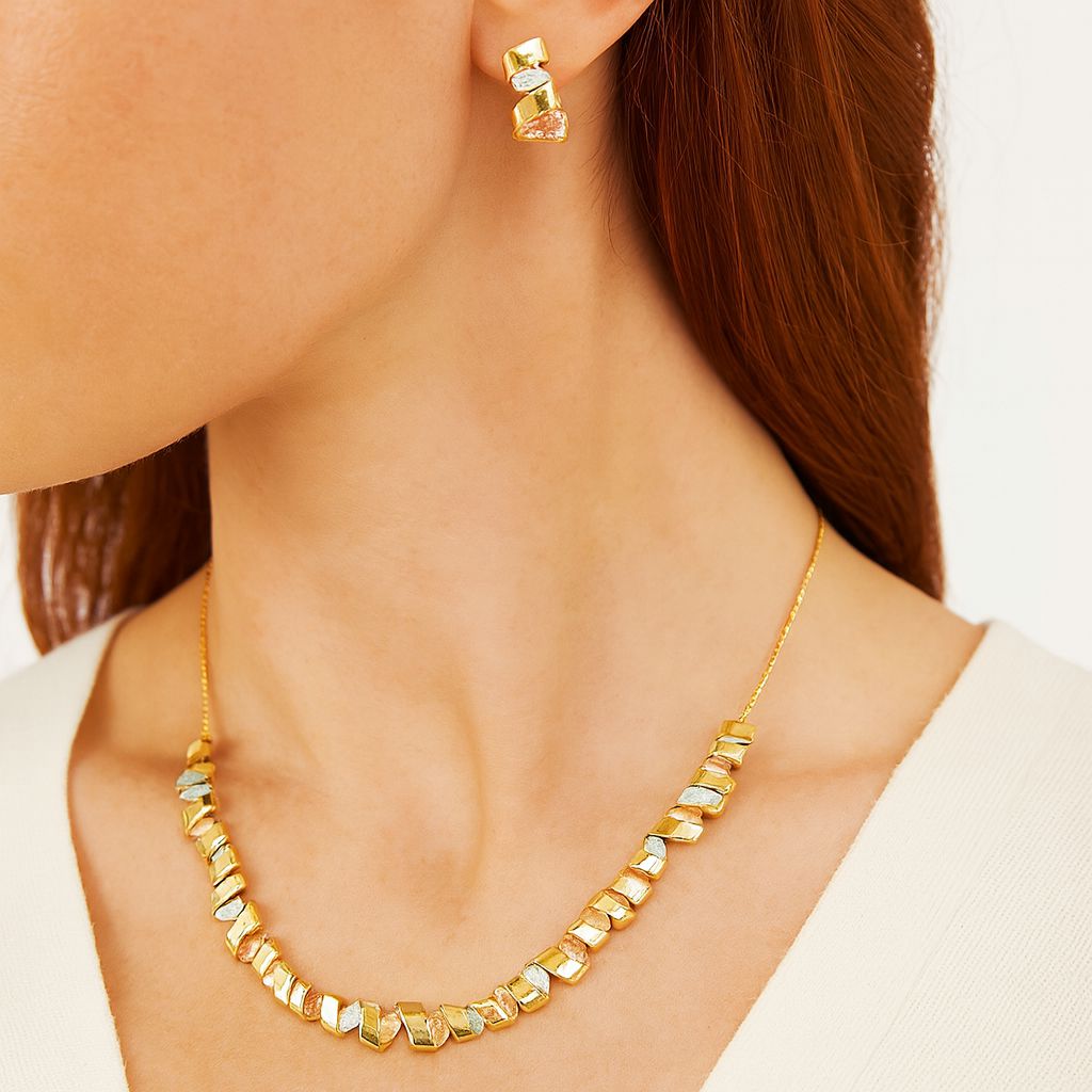 Model wearing geometric enamel necklace and matching earrings