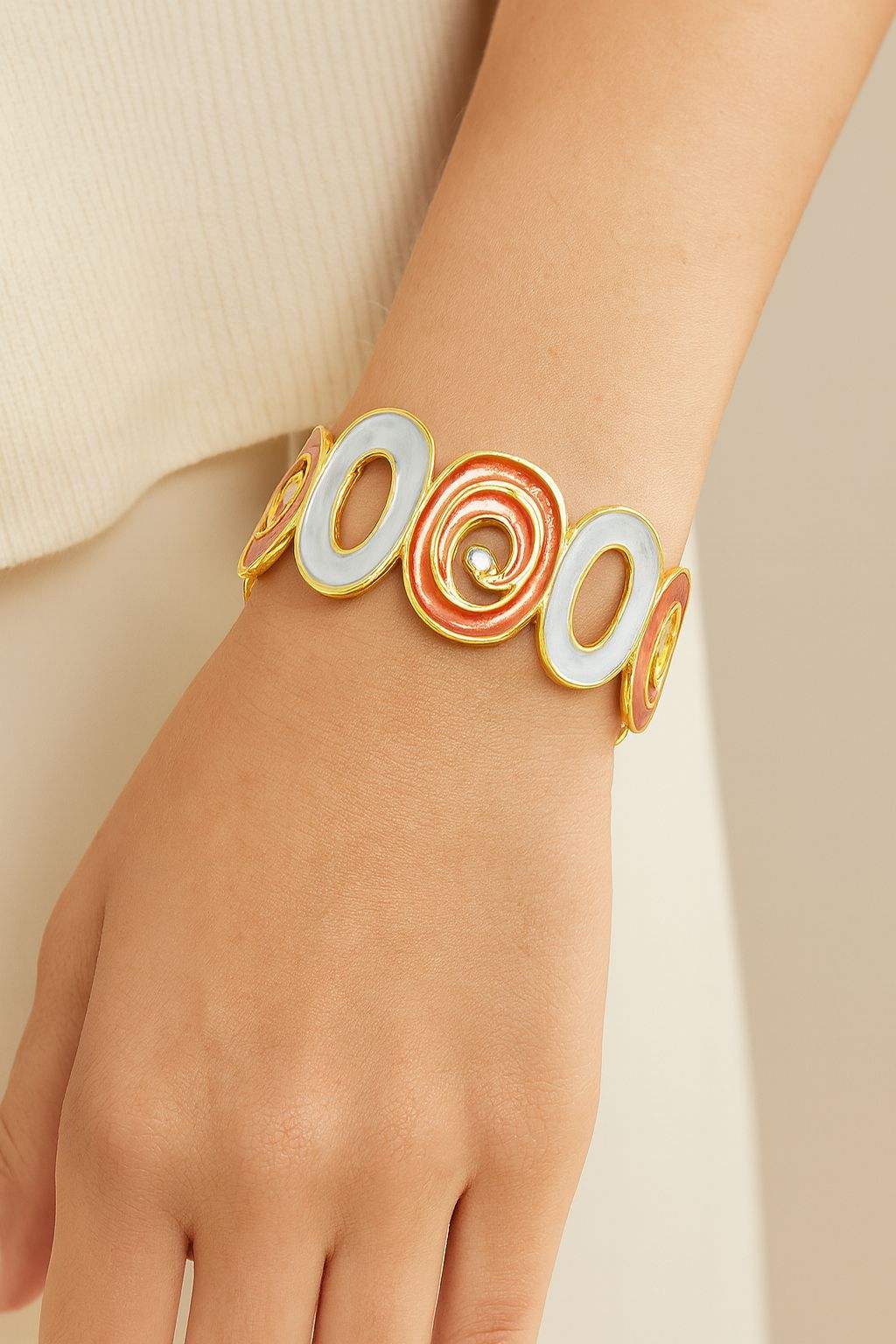 Model wearing spiral oval hand-painted gold bracelet