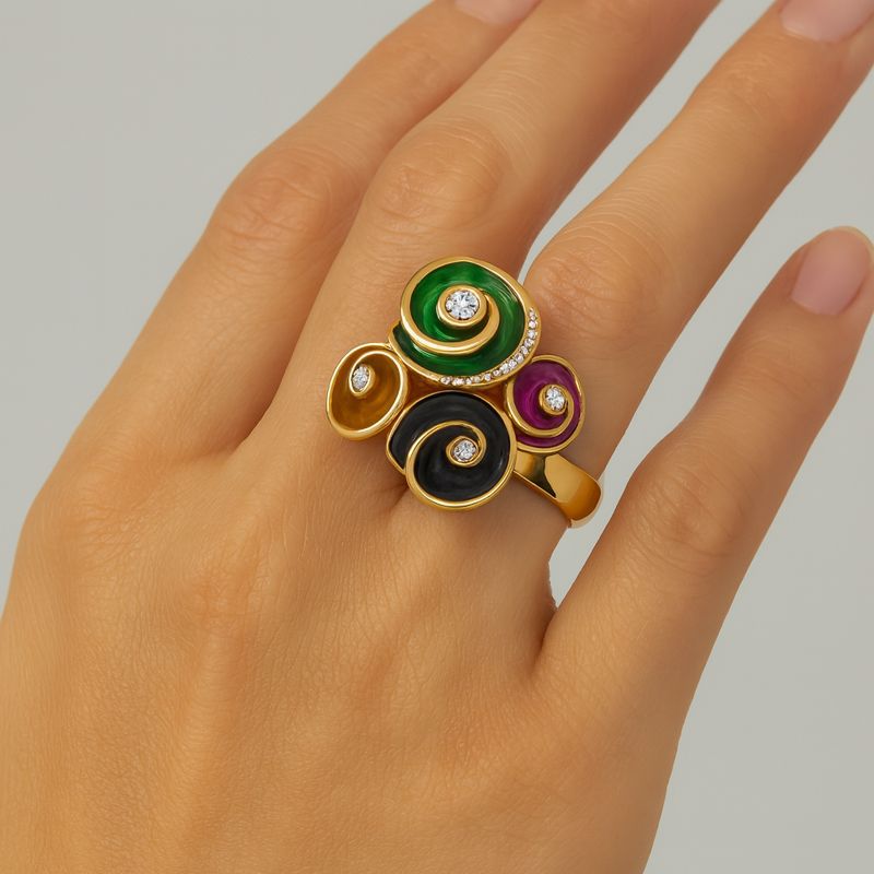 Close-up detail of hand painted enamel ring with glossy gold plating