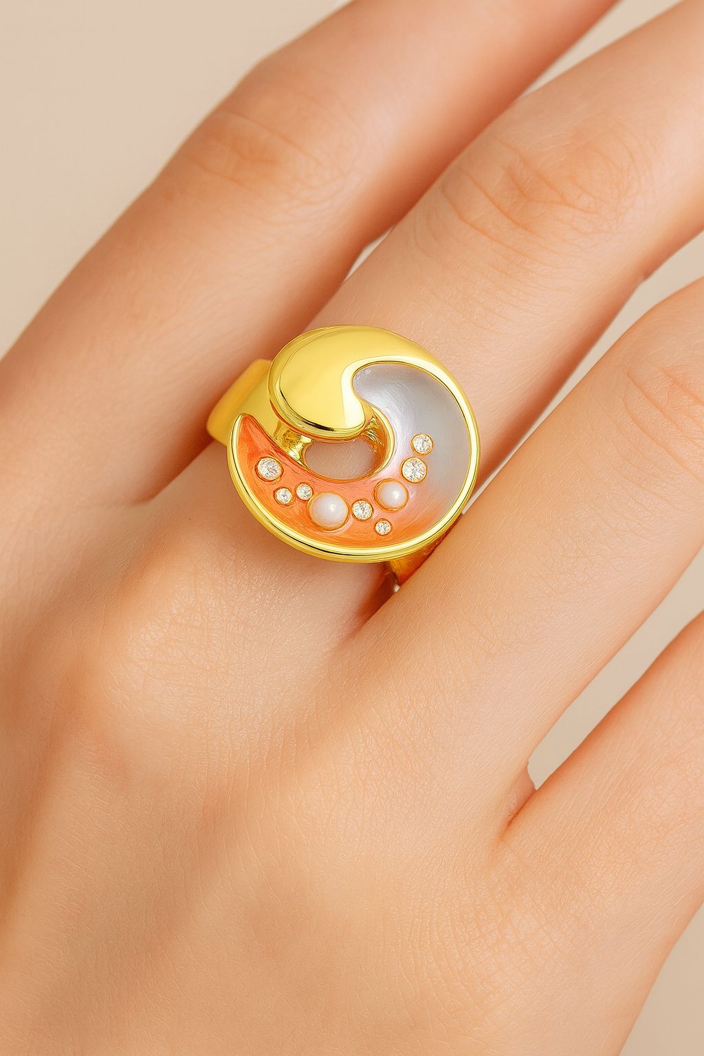 Close-up of hand-painted enamel wave ring with zircon stones