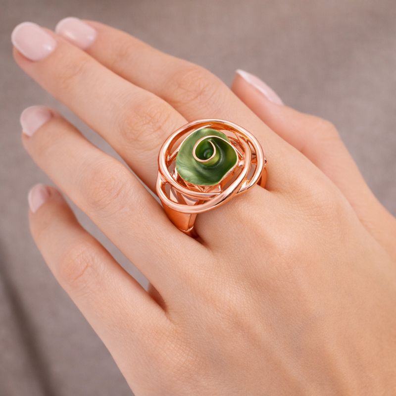 Close-up of hand-painted enamel swirl ring in rose gold
