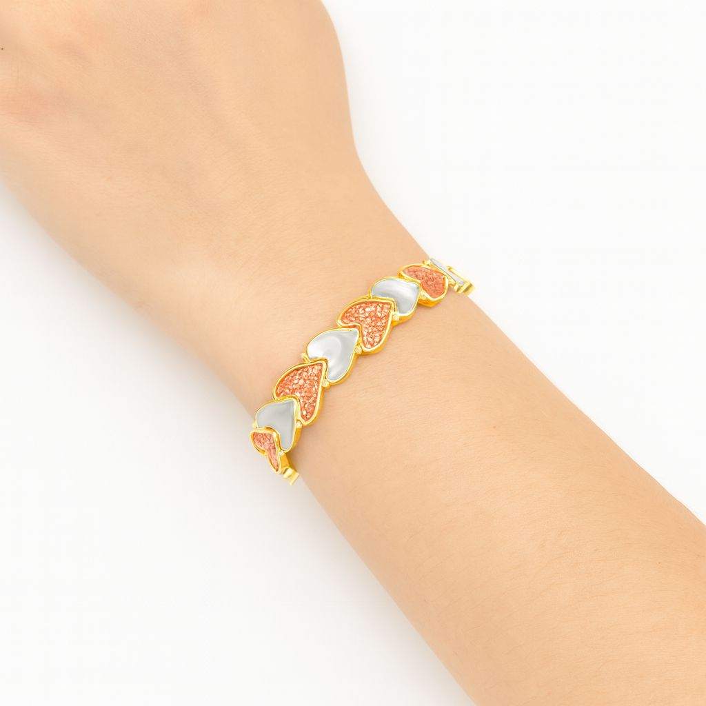 Model wearing KC gold heart enamel link bracelet