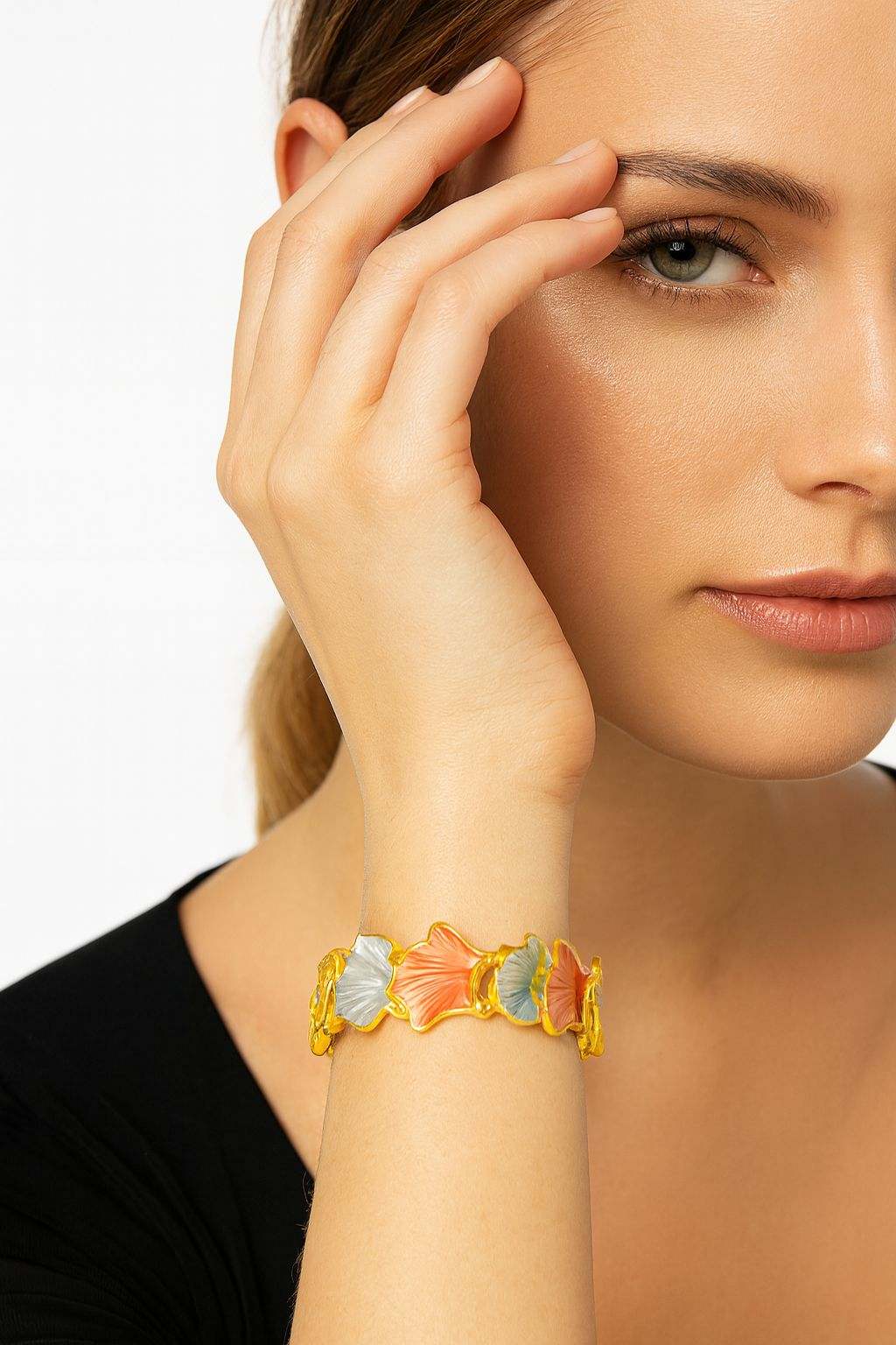 Women’s gold-plated floral bangle on wrist