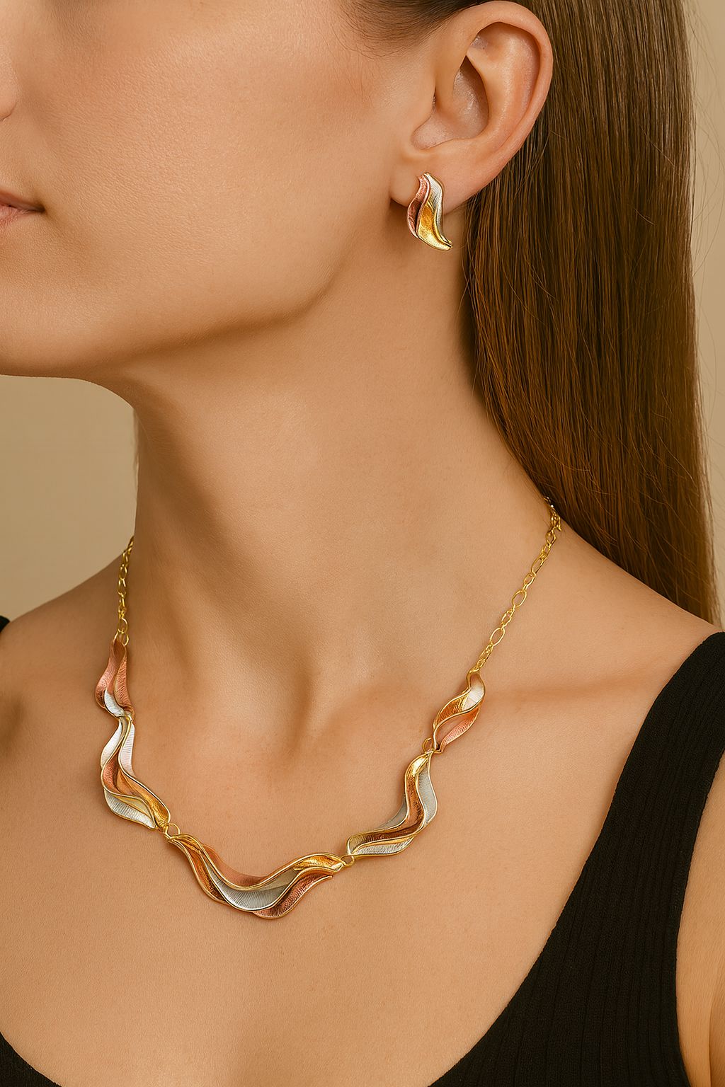 Gold plated artistic wave necklace shown on model