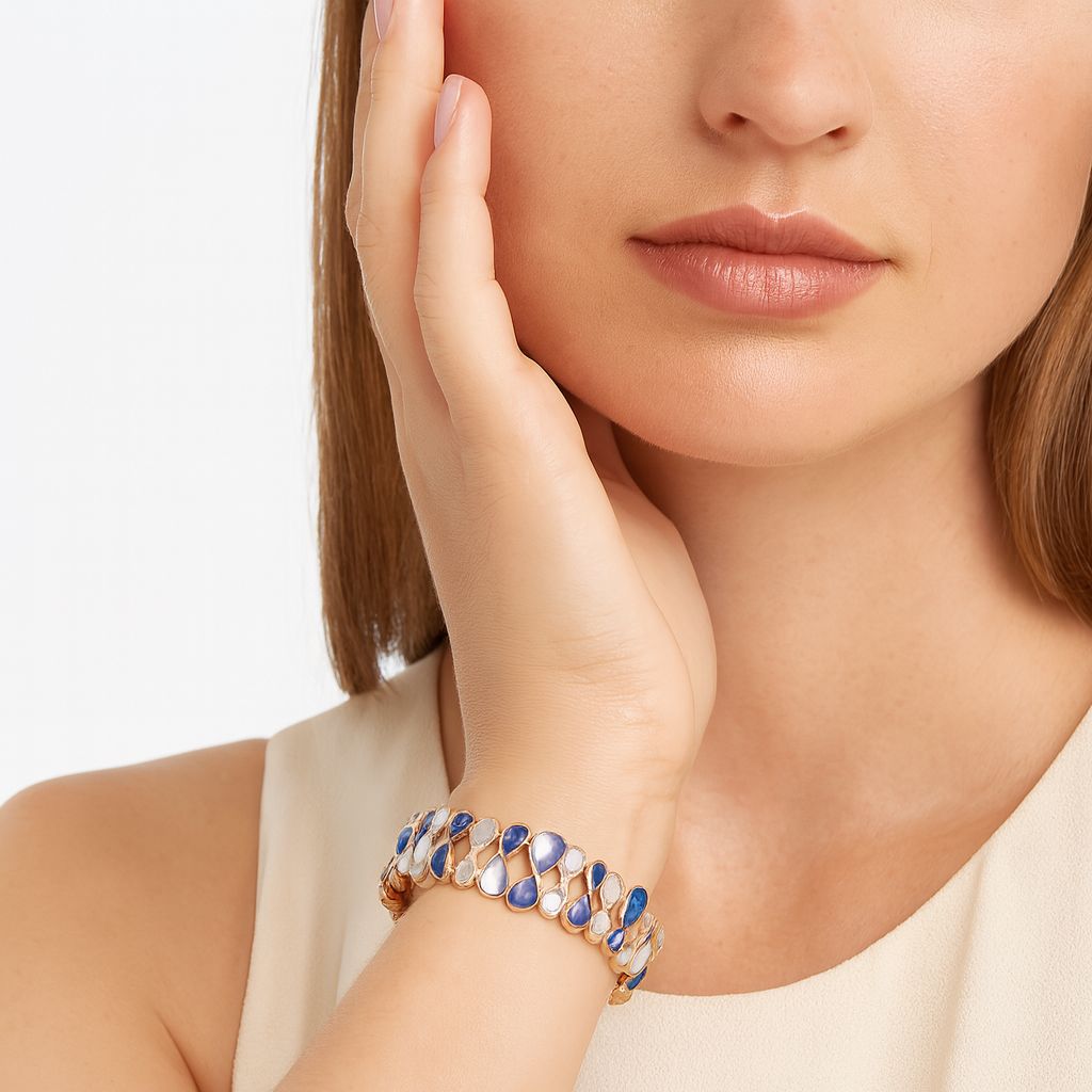 KC gold plated artistic bracelet with blue and white enamel accents