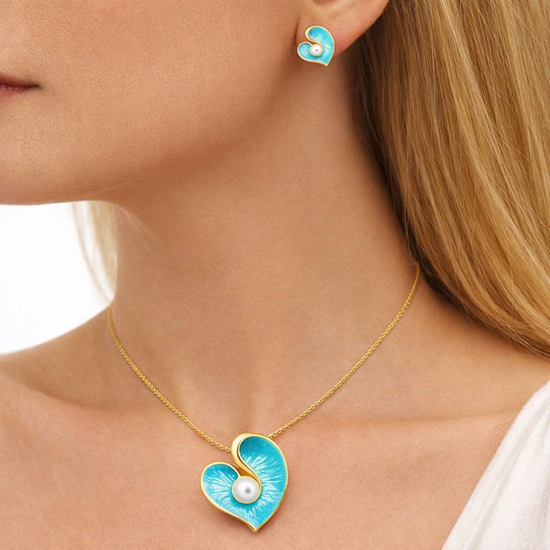 Heart shaped enamel stud earrings with KC gold plating worn by model