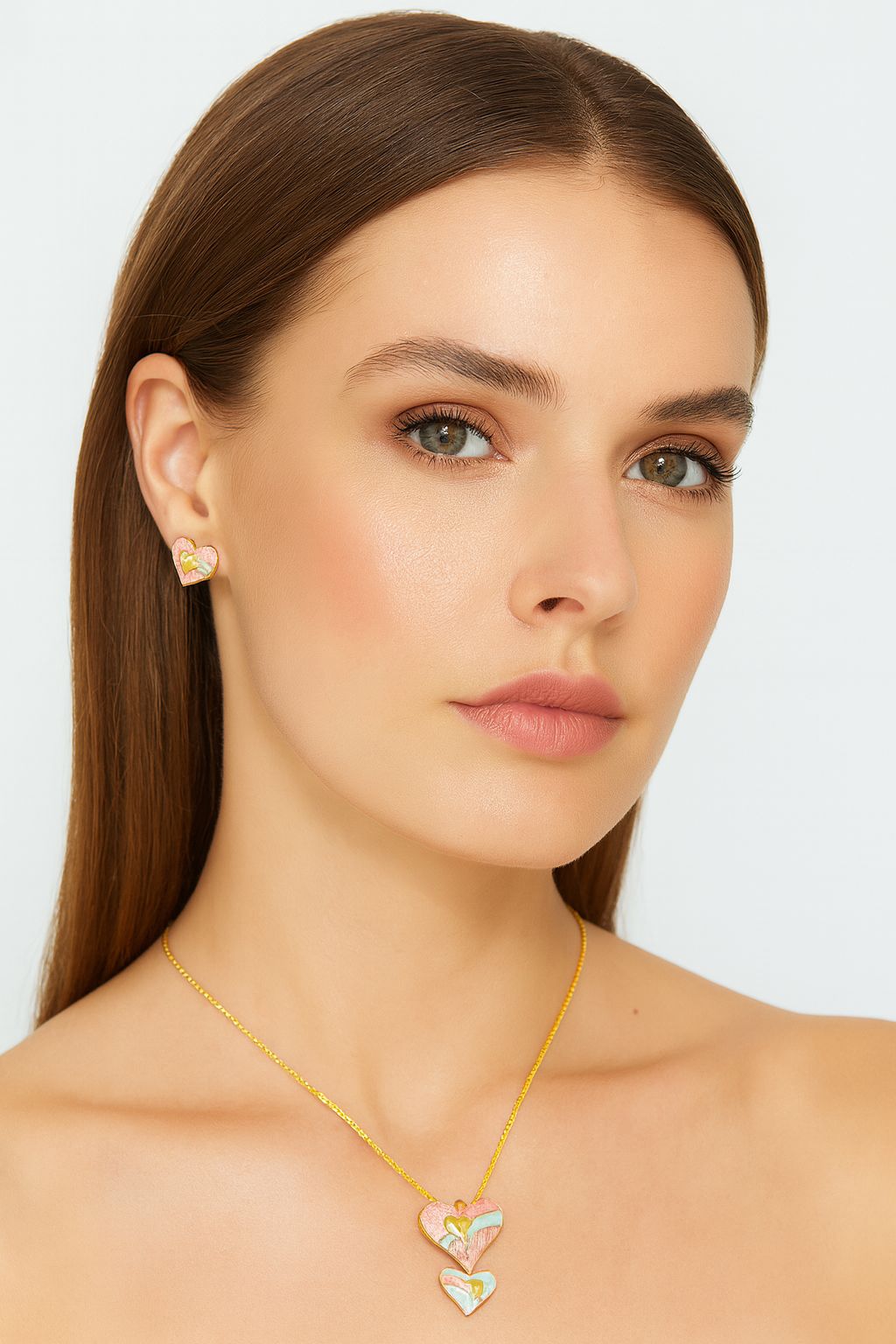 Model wearing heart-shaped pendant necklace and earrings