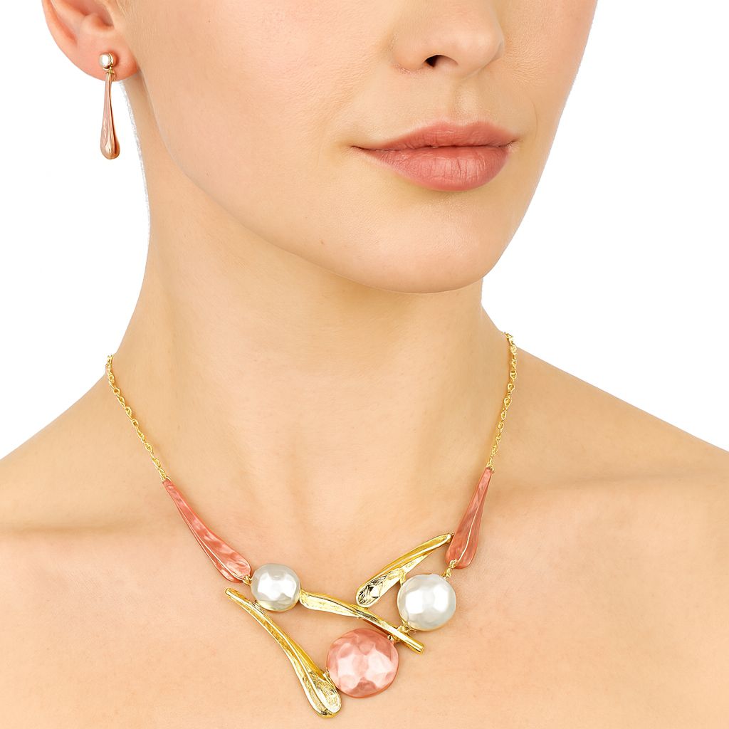 Close-up of gold plated enamel drop earrings on model