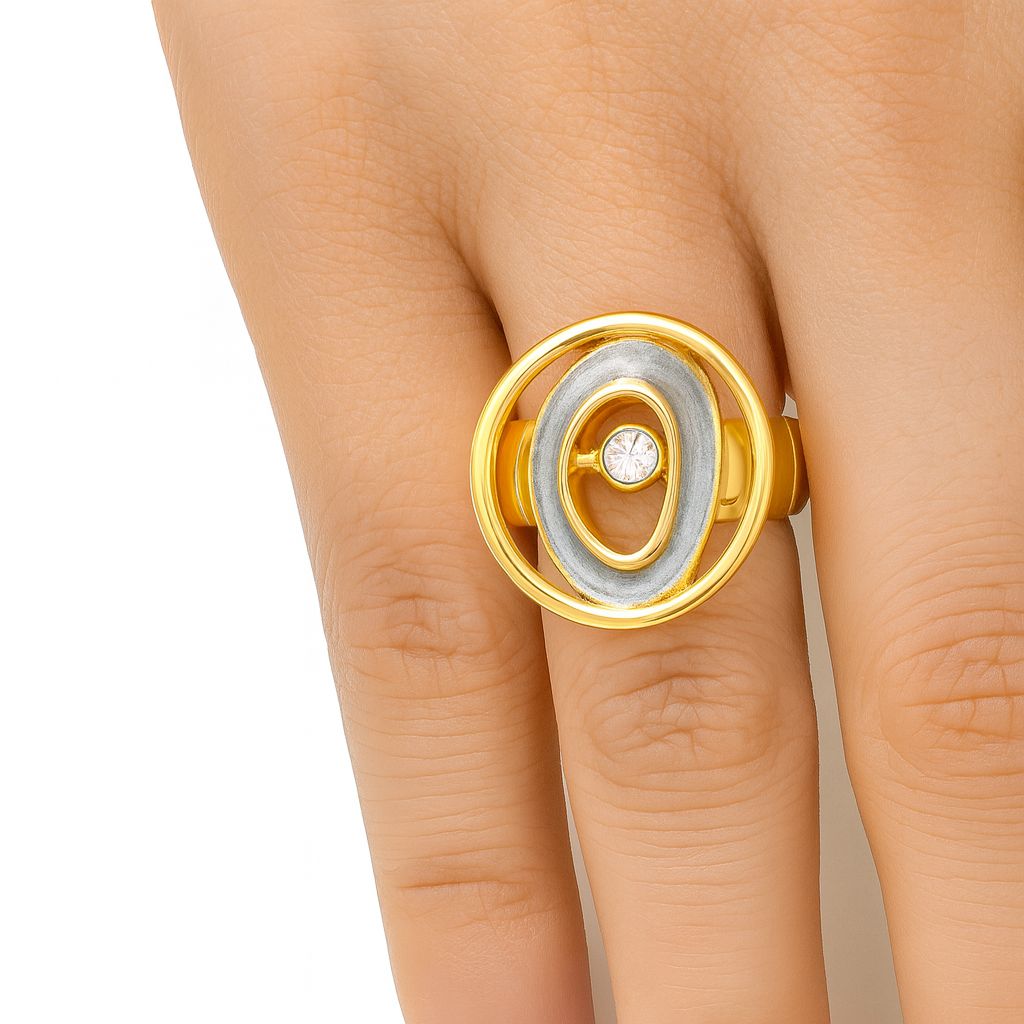 Close-up of adjustable gold spiral ring with hand-painted enamel