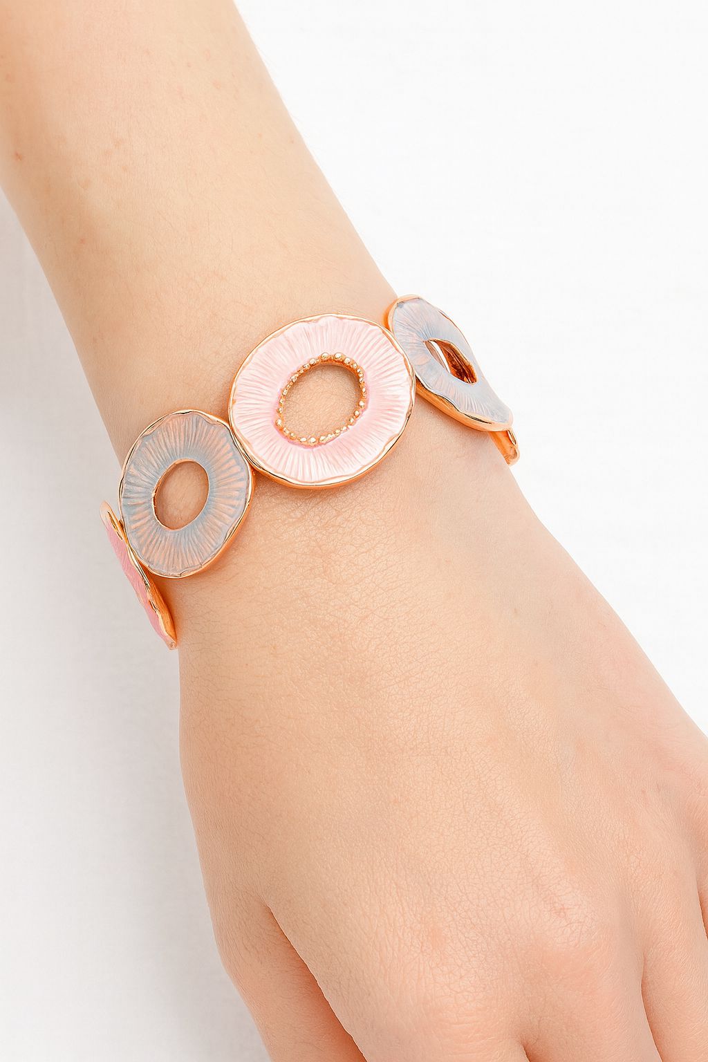 Model wearing pastel hand-painted gold bangle bracelet