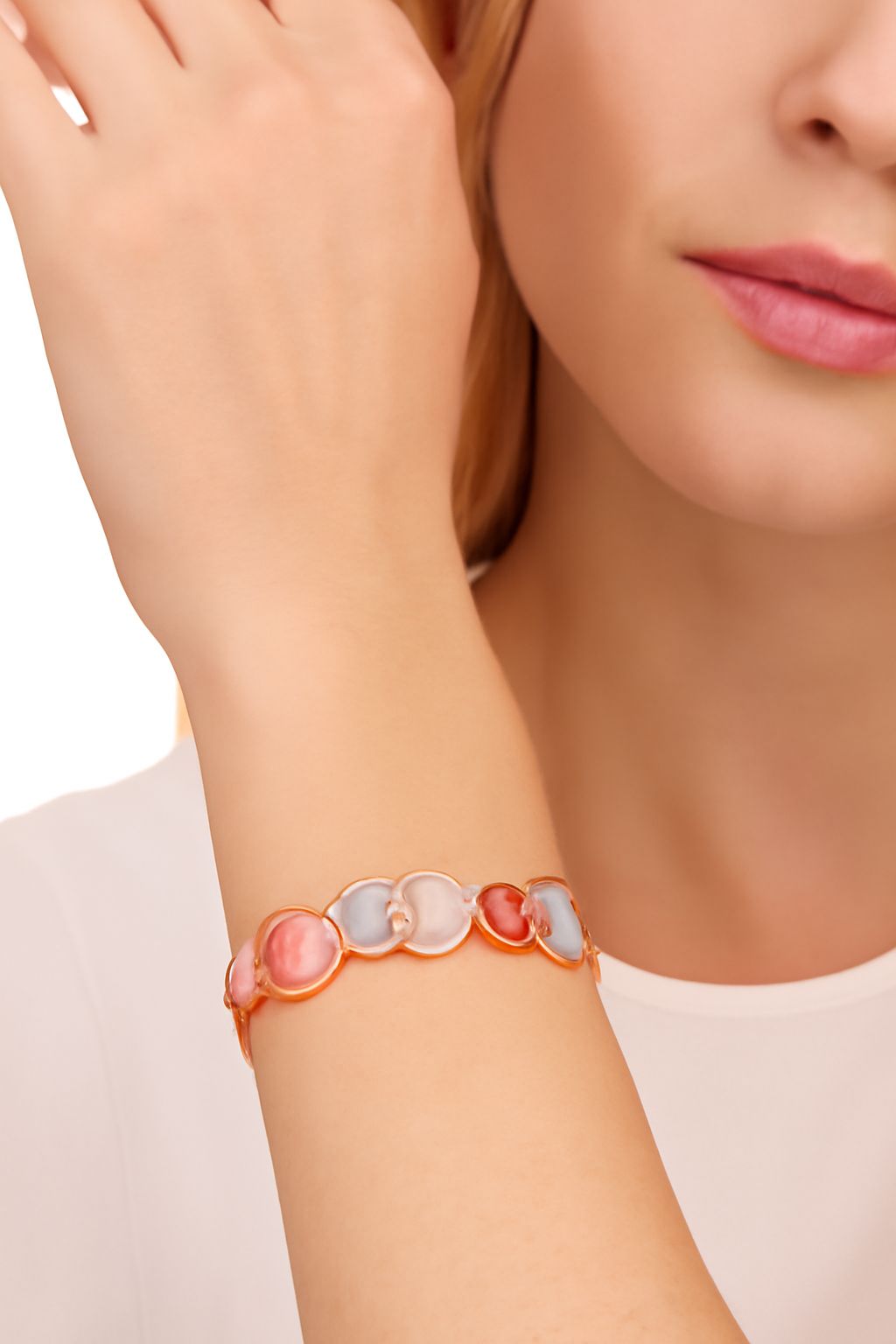 KC gold plated swirl bracelet worn on wrist