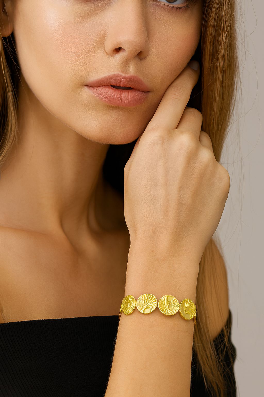 KC gold alloy bangle featuring textured circular elements