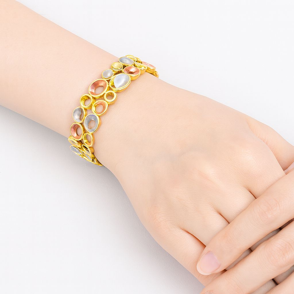Model wearing artistic enamel bracelet with KC gold plating