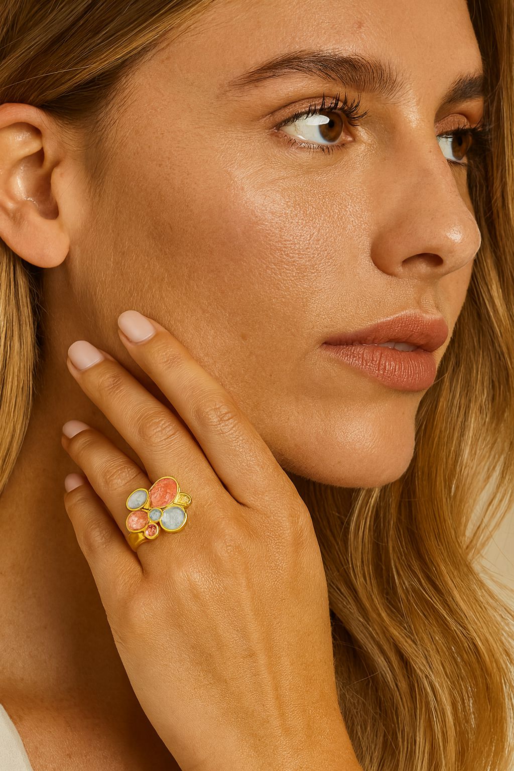 Model wearing artistic KC gold enamel orb ring on hand