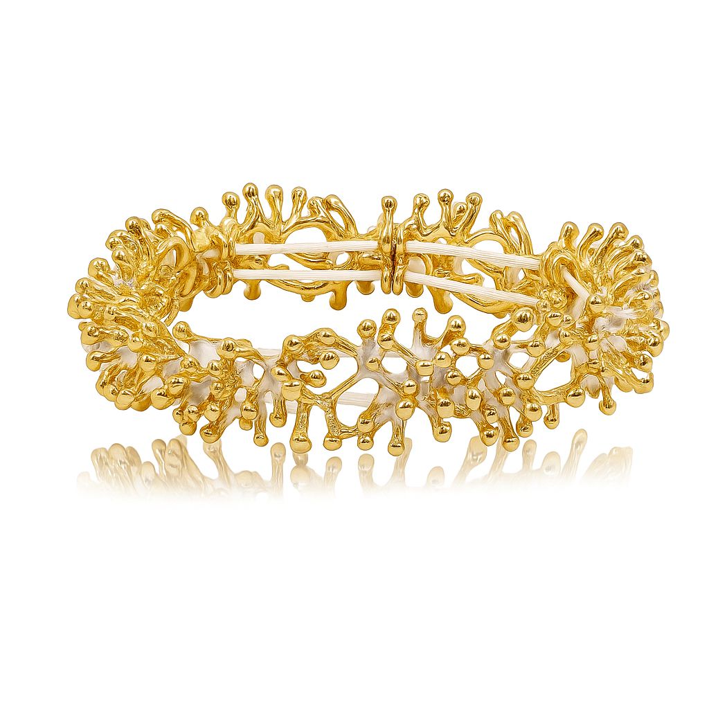 “Artisan gold-plated alloy bracelet featuring textured enamel design”