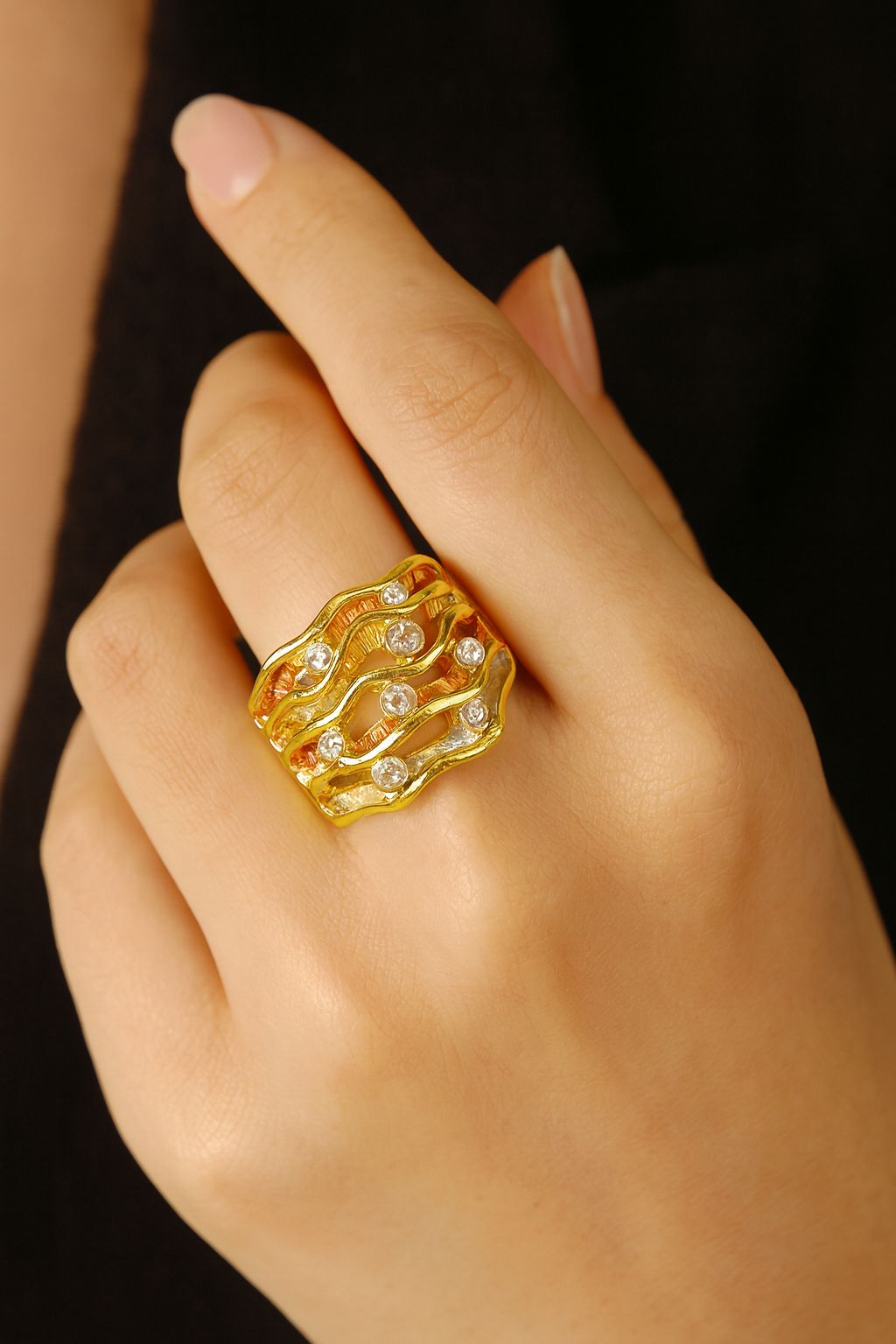 Artistic wide band ring with crystal accents in gold finish