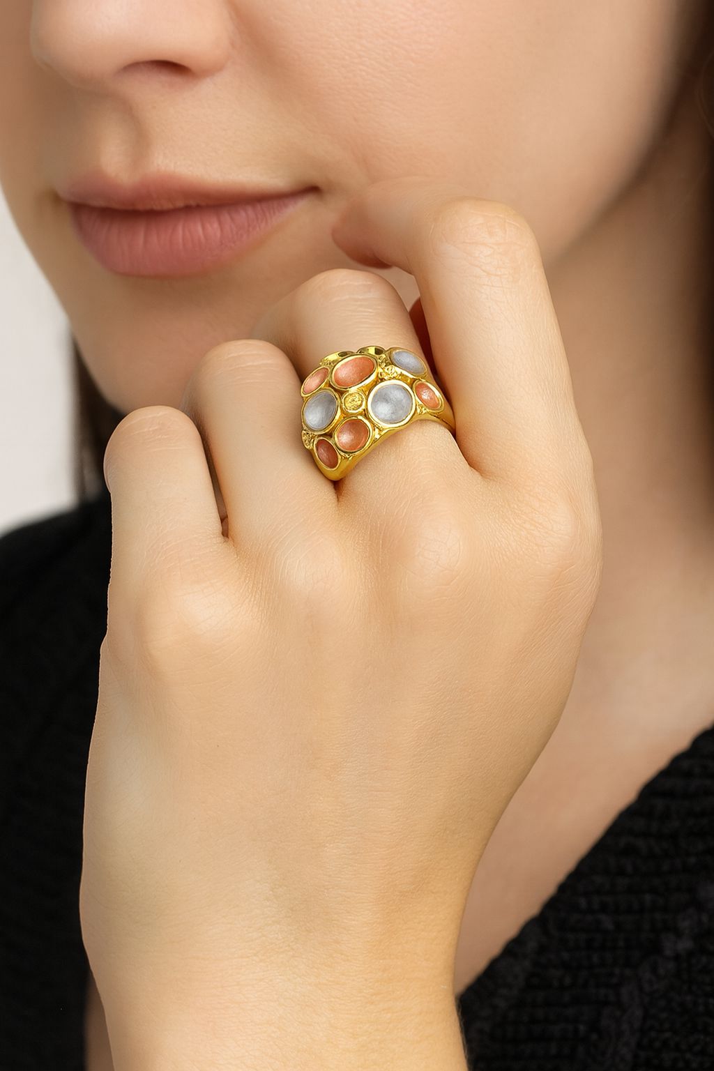 “Hand-painted enamel fashion ring on model’s hand”