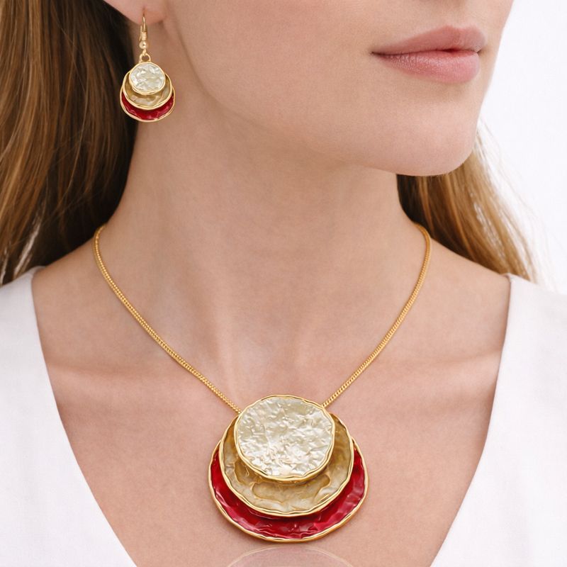 Close up of hand painted enamel necklace in gold plated alloy