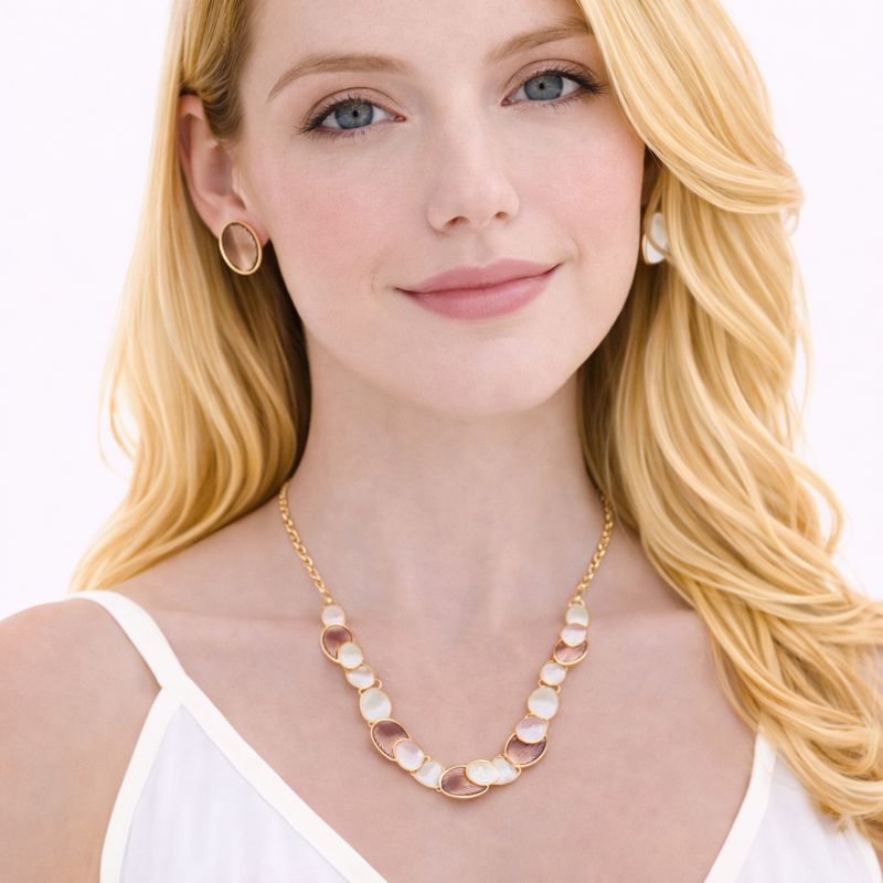 Model wearing KC gold hand-painted enamel necklace and earrings set