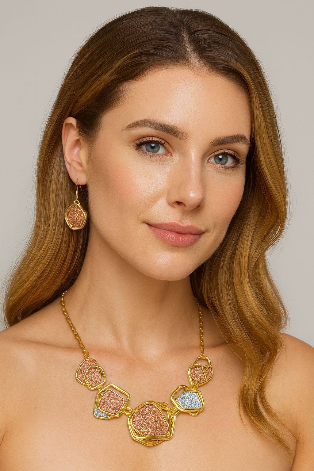 Model wearing geometric textured necklace and matching earrings