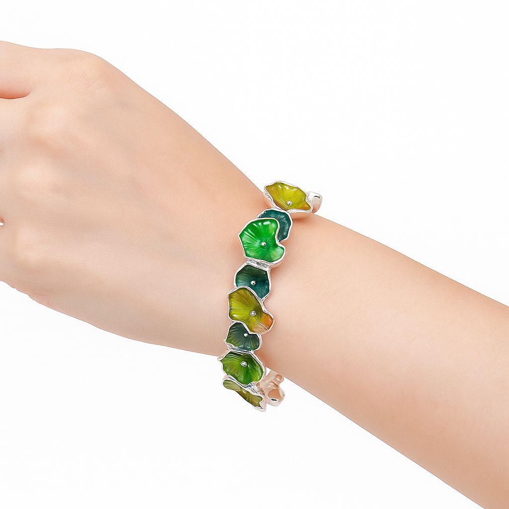 Side view of artistic green ginkgo leaf bangle with hand-painted enamel