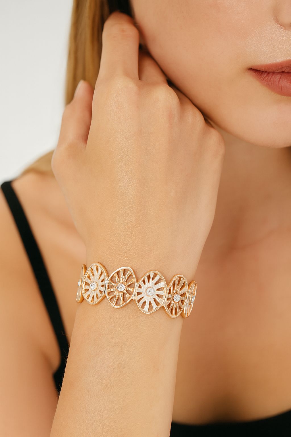 woman wearing KC gold openwork crystal bangle bracelet hand-painted enamel