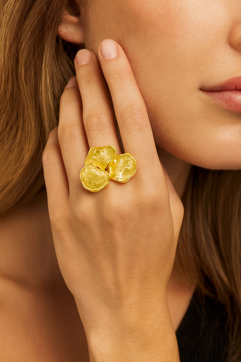 Organic-shaped gold ring worn on female hand