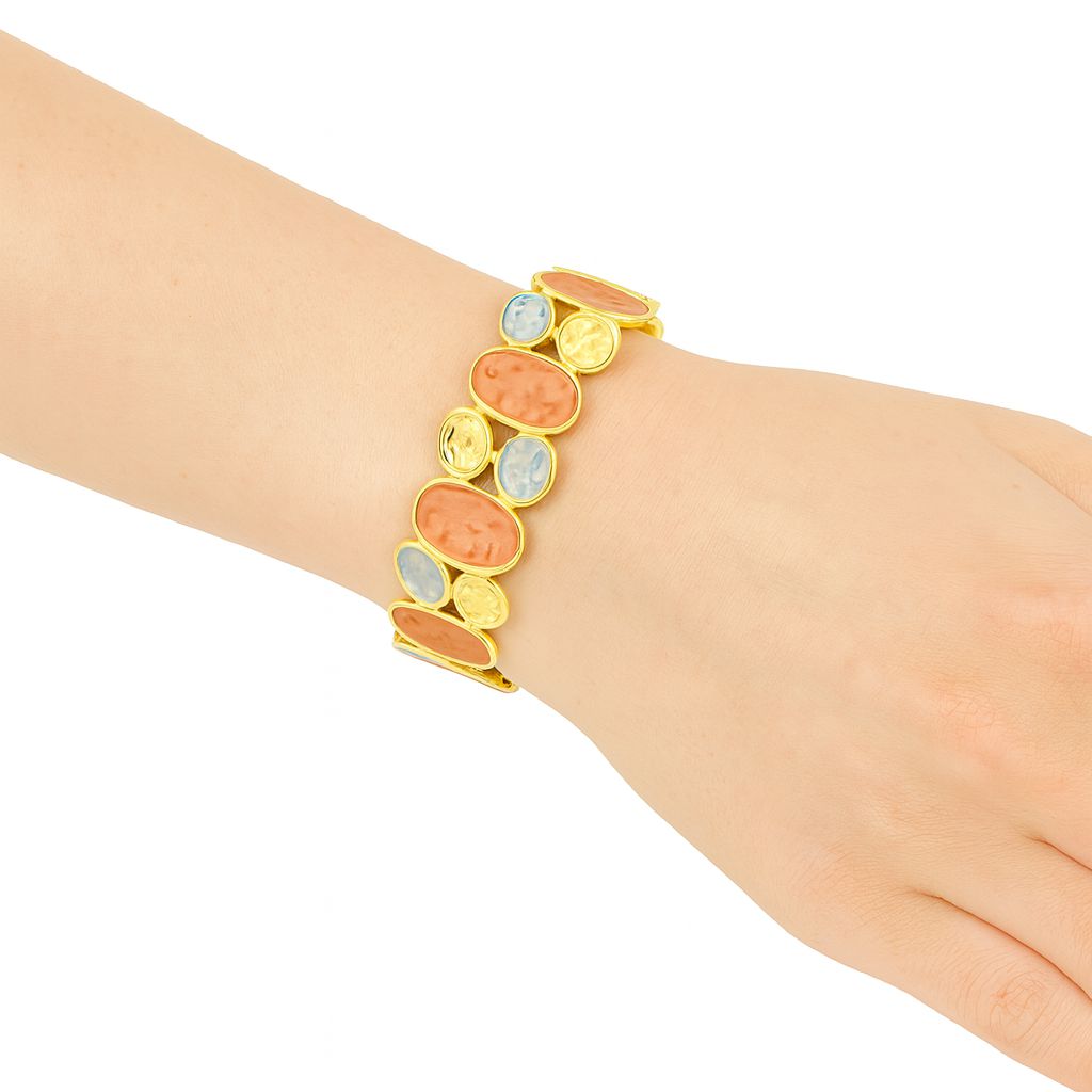 KC gold oval bracelet on wrist – textured enamel design