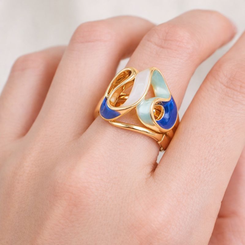 Close-up of KC gold plated ring with layered hand-painted enamel details