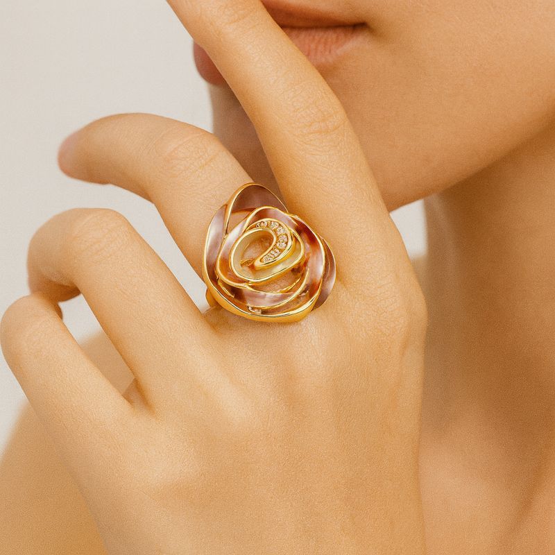 Close-up of KC gold plated spiral ring with hand-painted enamel