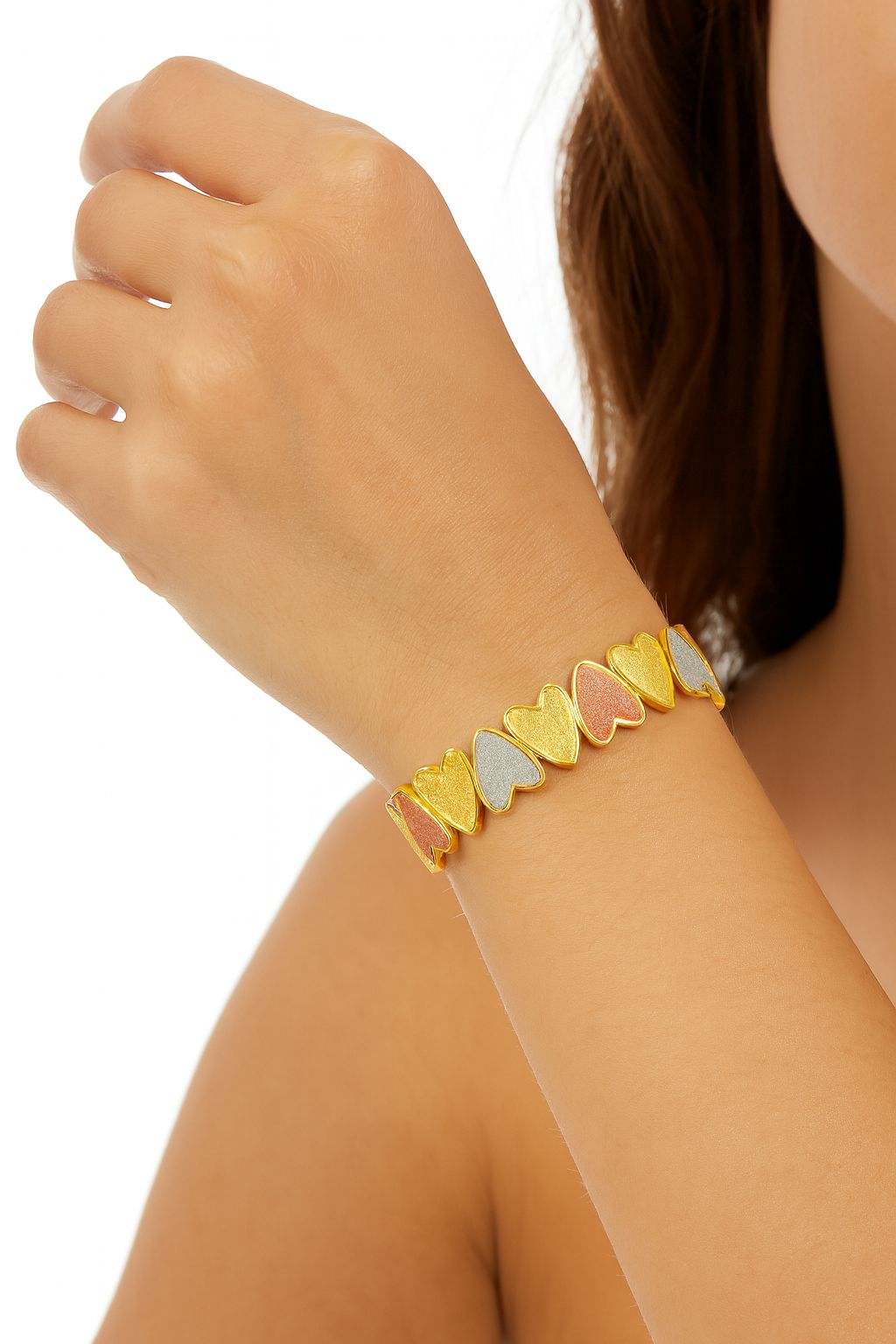 KC gold plated tri-color heart link bracelet with hand-painted glitter texture on woman's wrist