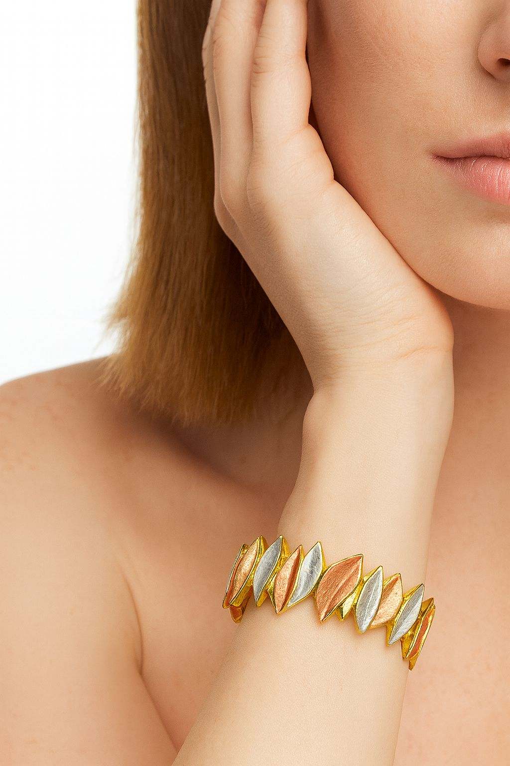Model wearing tri-color leaf-pattern gold bracelet