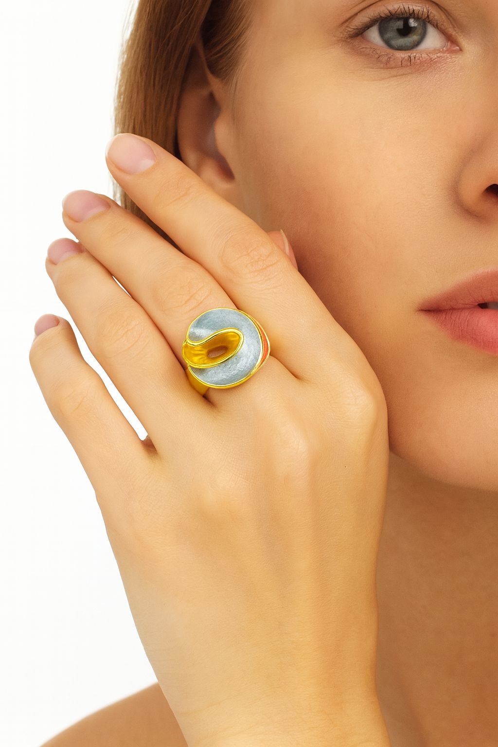 Artistic KC gold plated adjustable ring with hand-painted enamel swirl shown on model hand