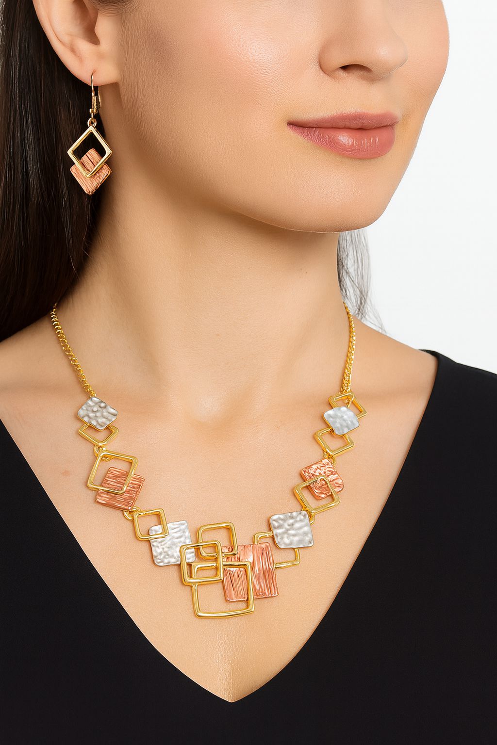 Model wearing KC gold plated geometric necklace and drop earrings