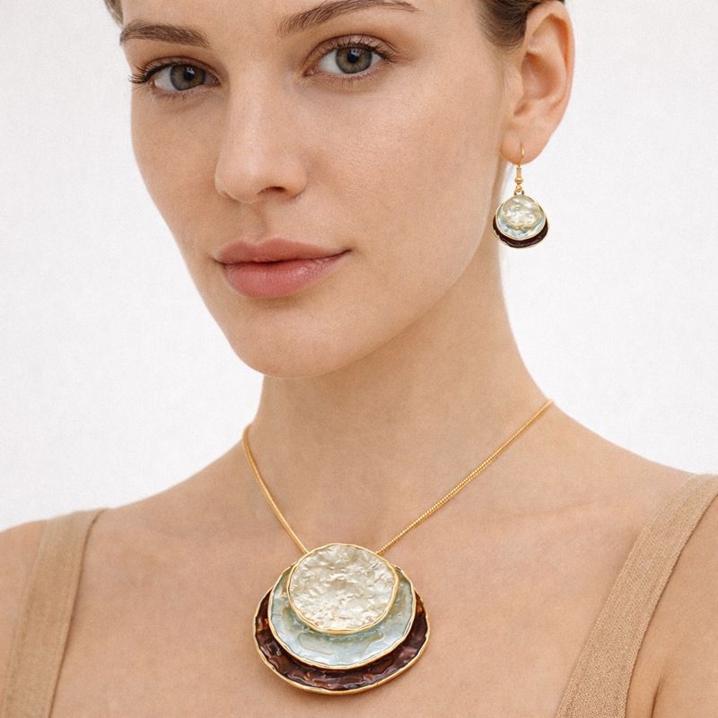 Hand-painted layered disc necklace and earrings worn by model