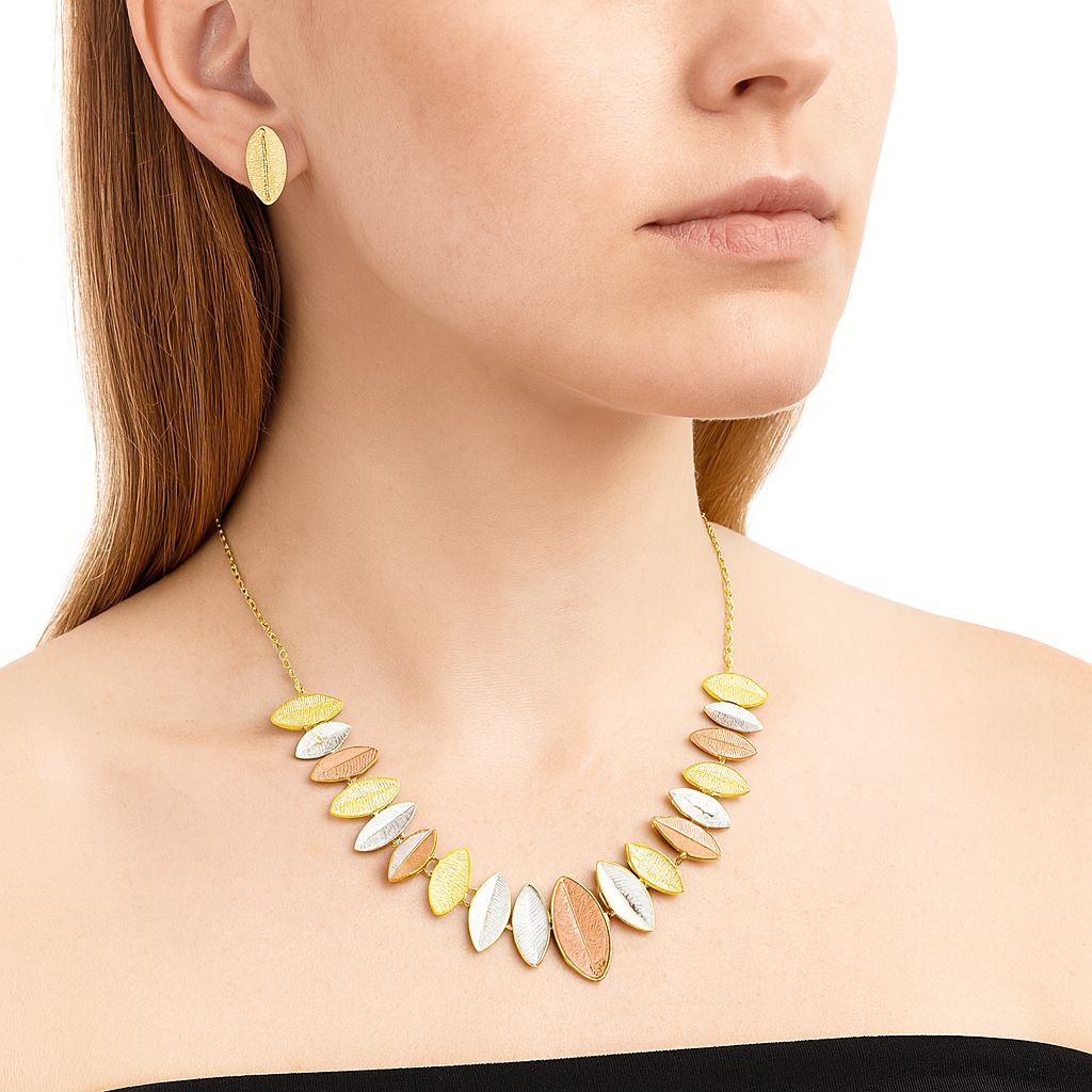 Model wearing tri-color leaf pendant necklace and earrings