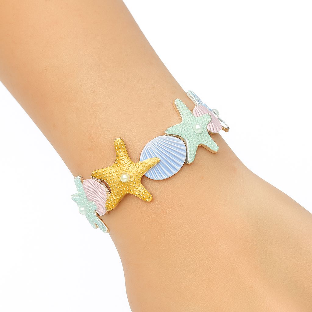 Model wearing ocean inspired starfish seashell bracele