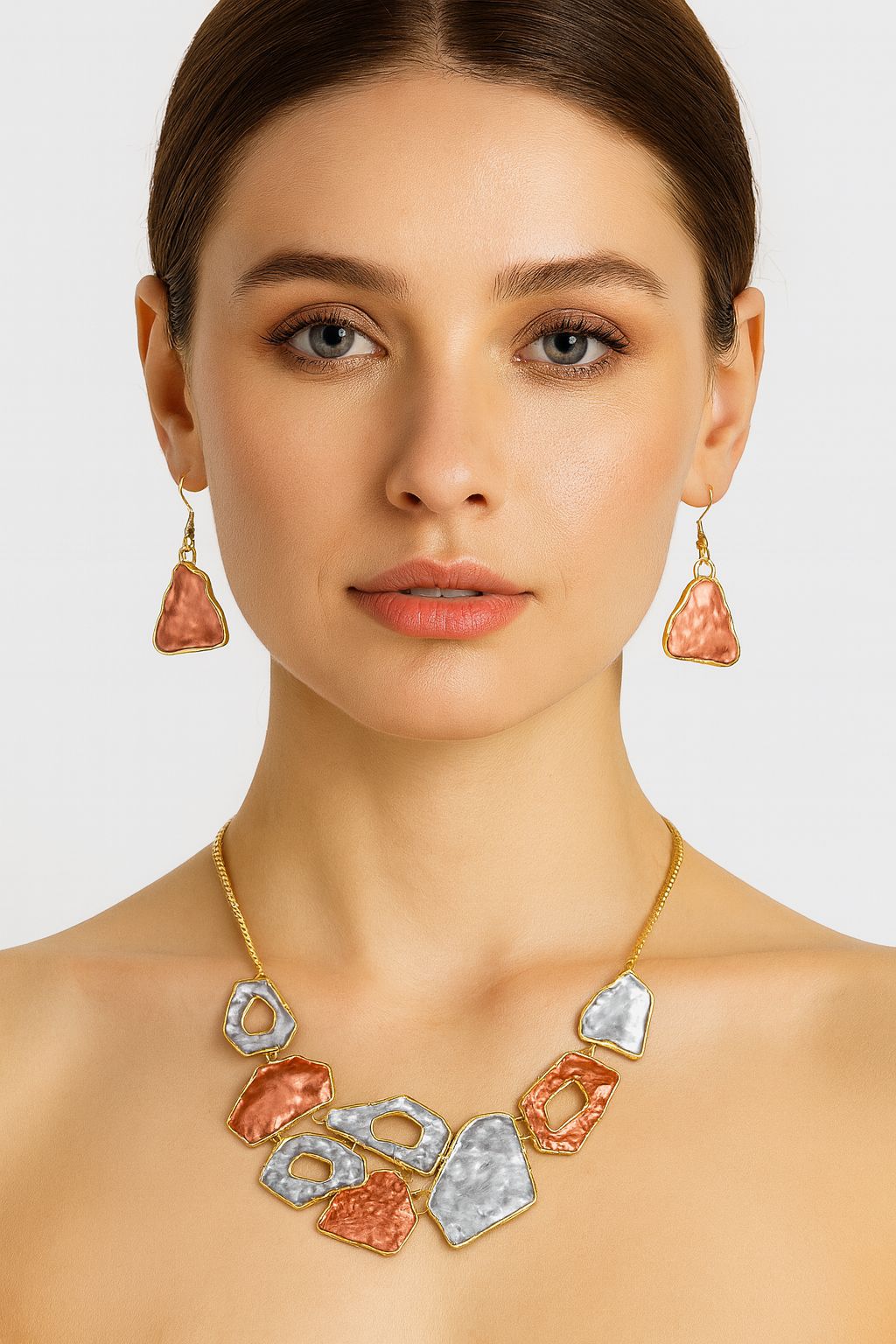 Model wearing hammered metal necklace and earring set with KC gold plating