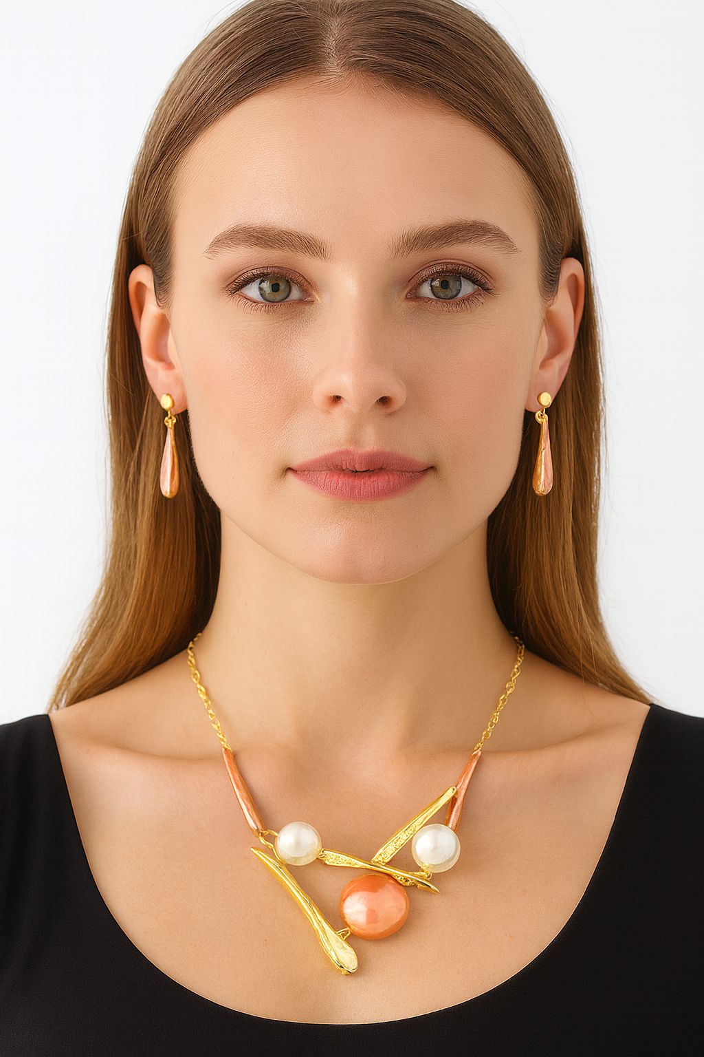 Model wearing abstract pearl and enamel necklace with matching earrings