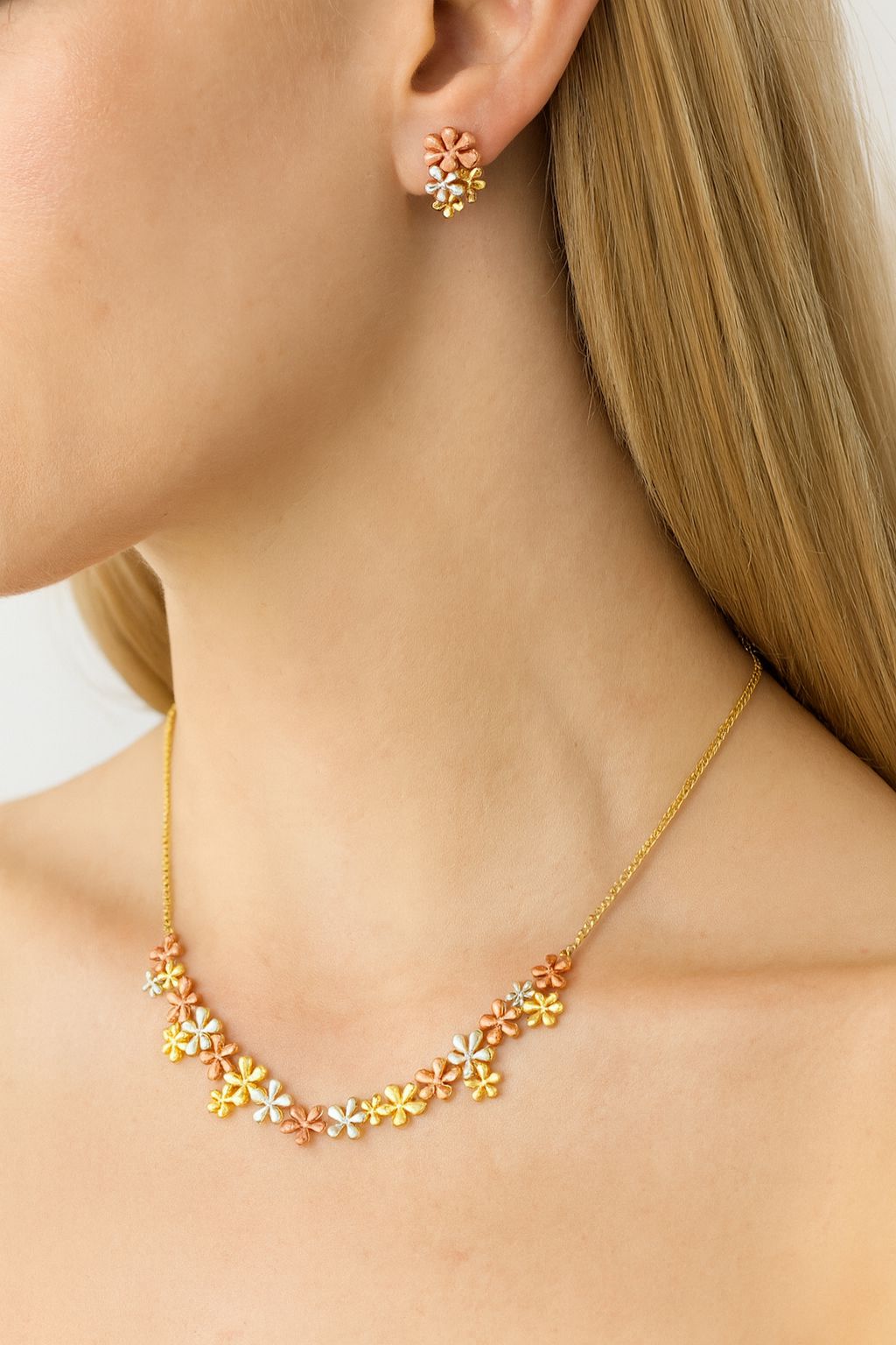 Model wearing floral enamel gold plated earrings