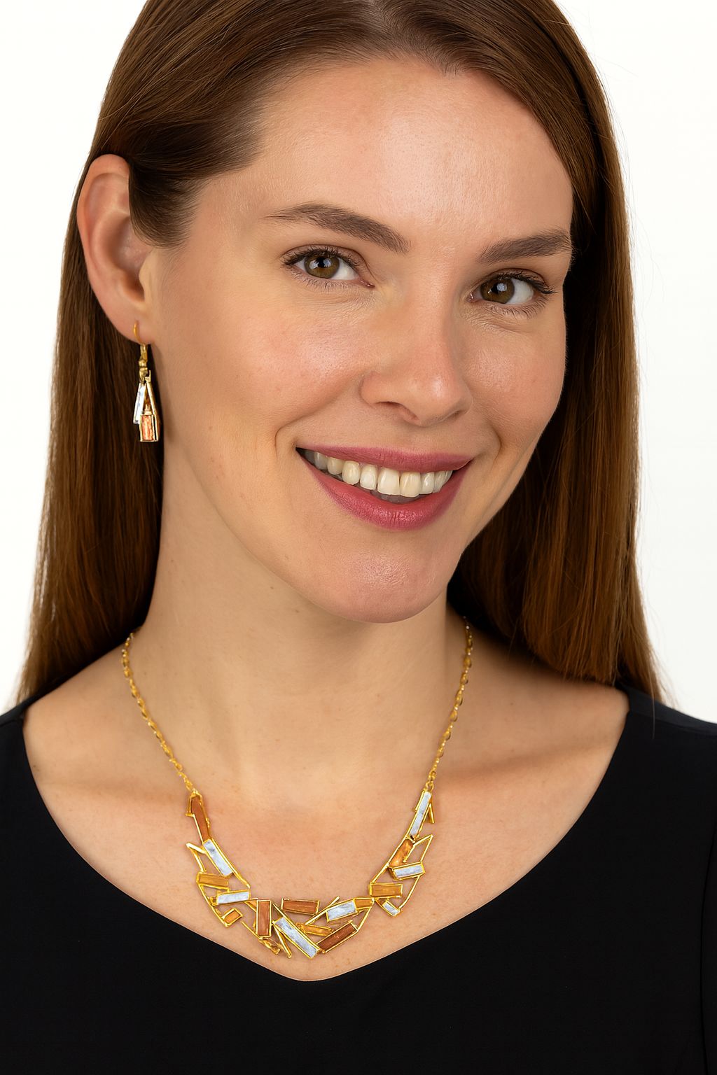 “Model wearing geometric artistic enamel necklace in KC gold finish”

