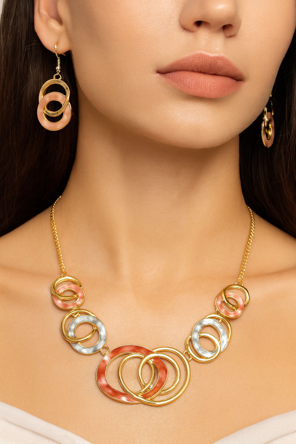 Model wearing gold drip necklace and matching earrings
