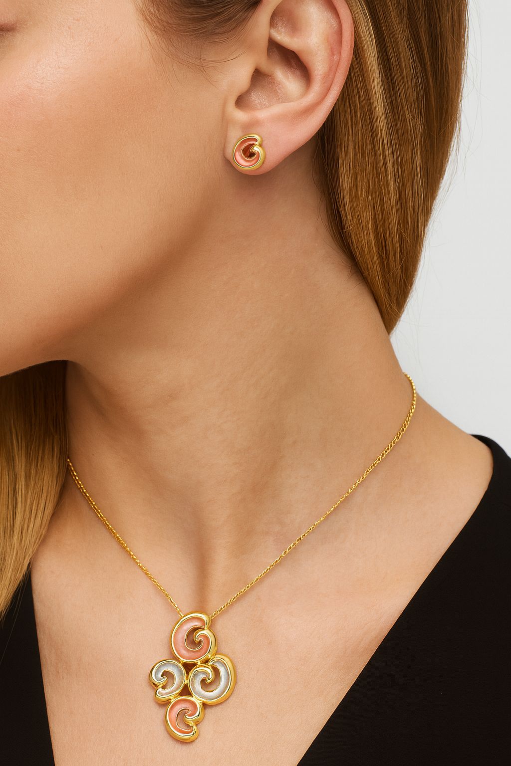 Close-up of hand-painted swirl pendant with KC gold finish