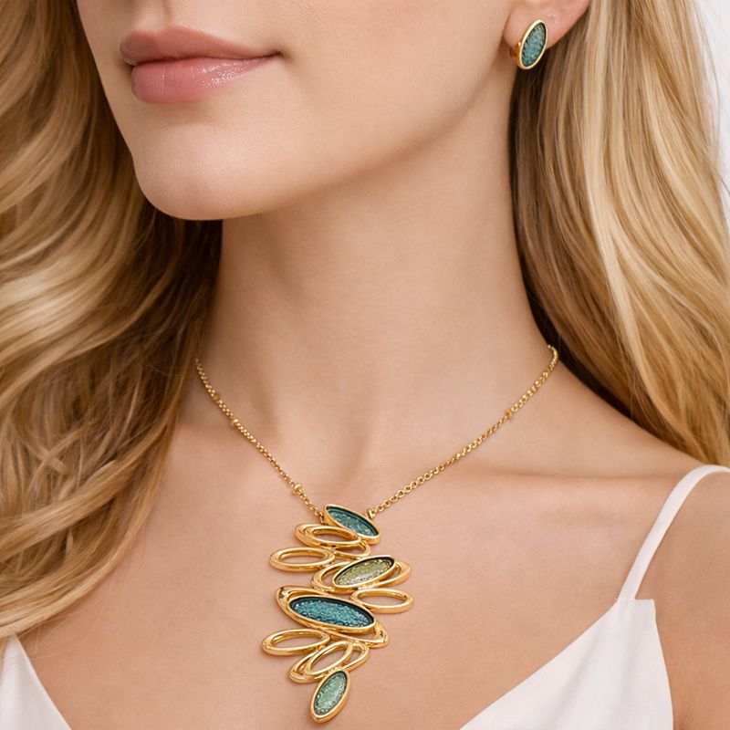 Modern abstract oval necklace and earrings worn by model