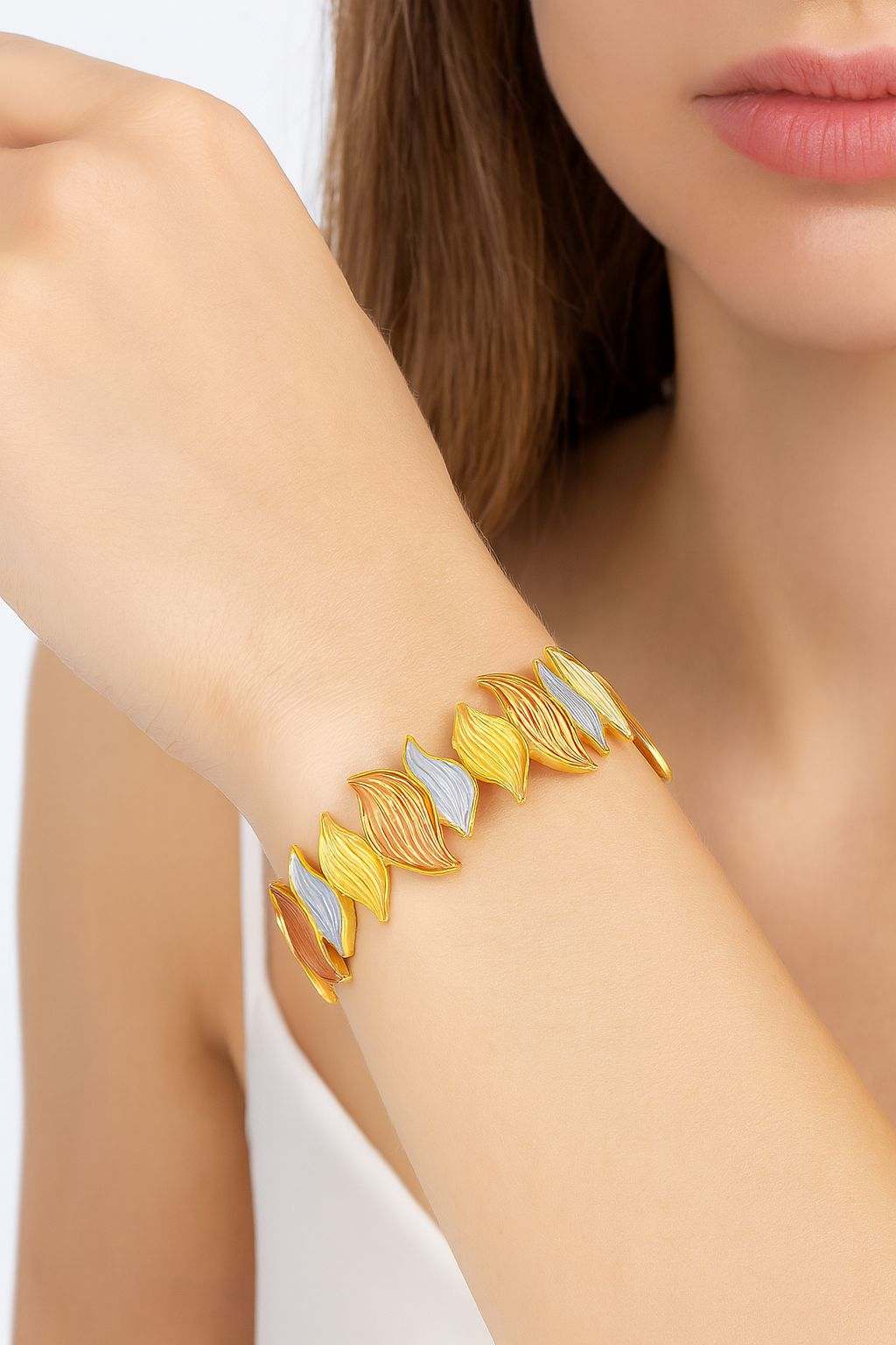 KC gold-plated leaf texture bracelet with hand-painted multi-color enamel on woman's wrist