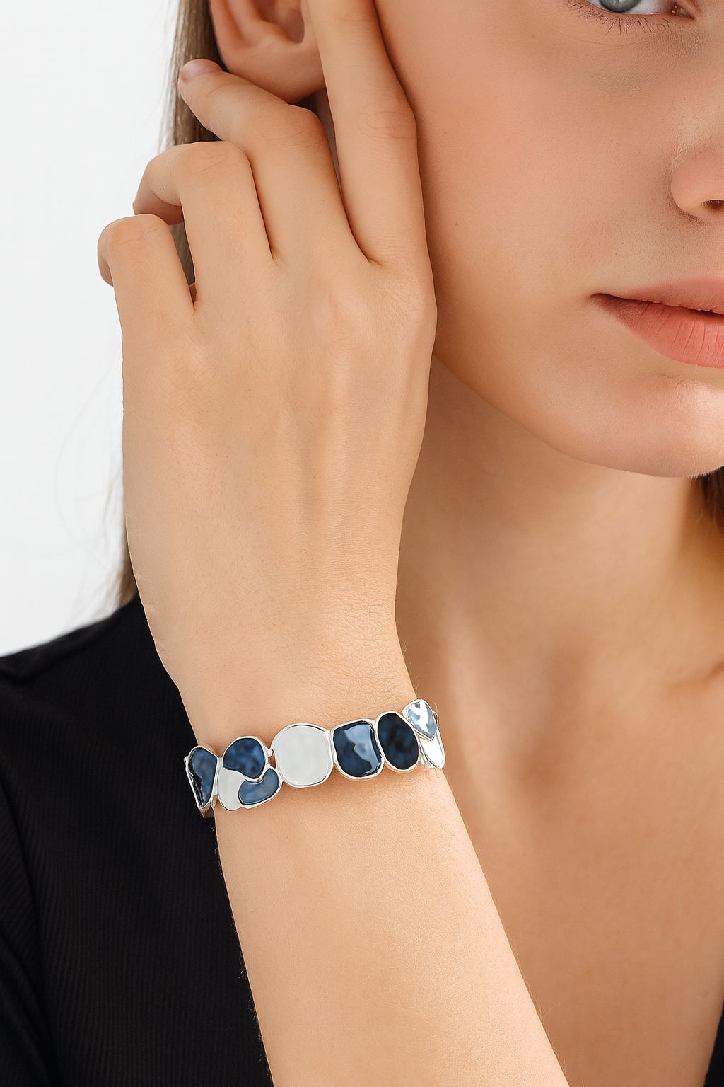 Model wearing ocean-inspired blue and white enamel bangle