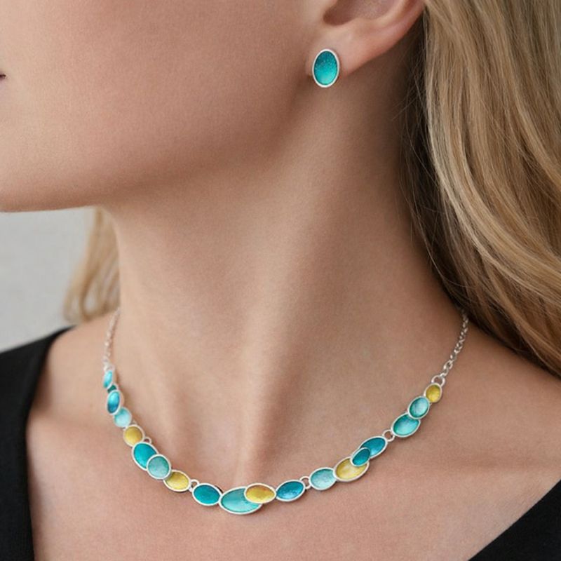 Oval enamel stud earrings with KC gold plating worn by model